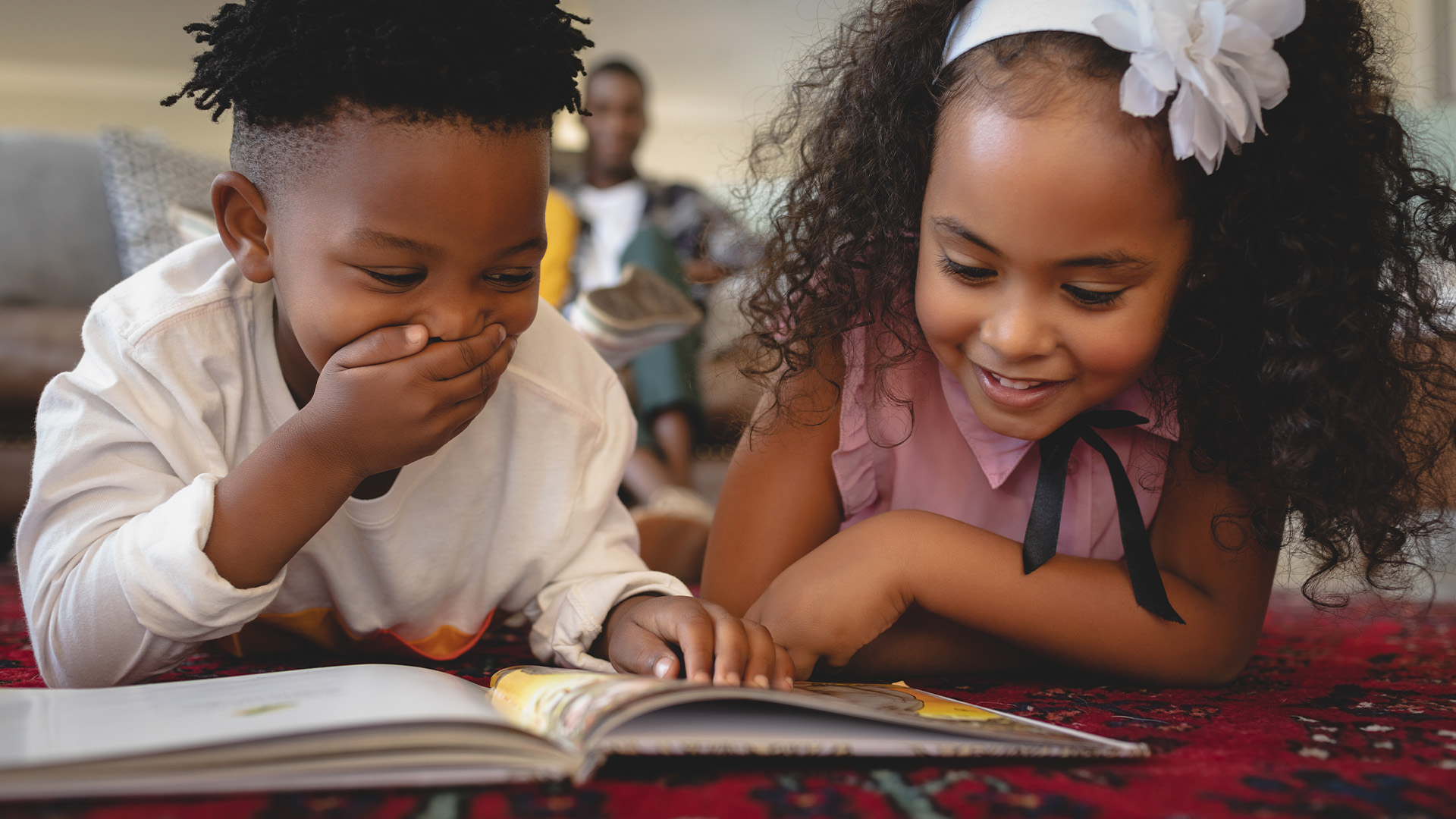 Children reading book together © Shutterstock