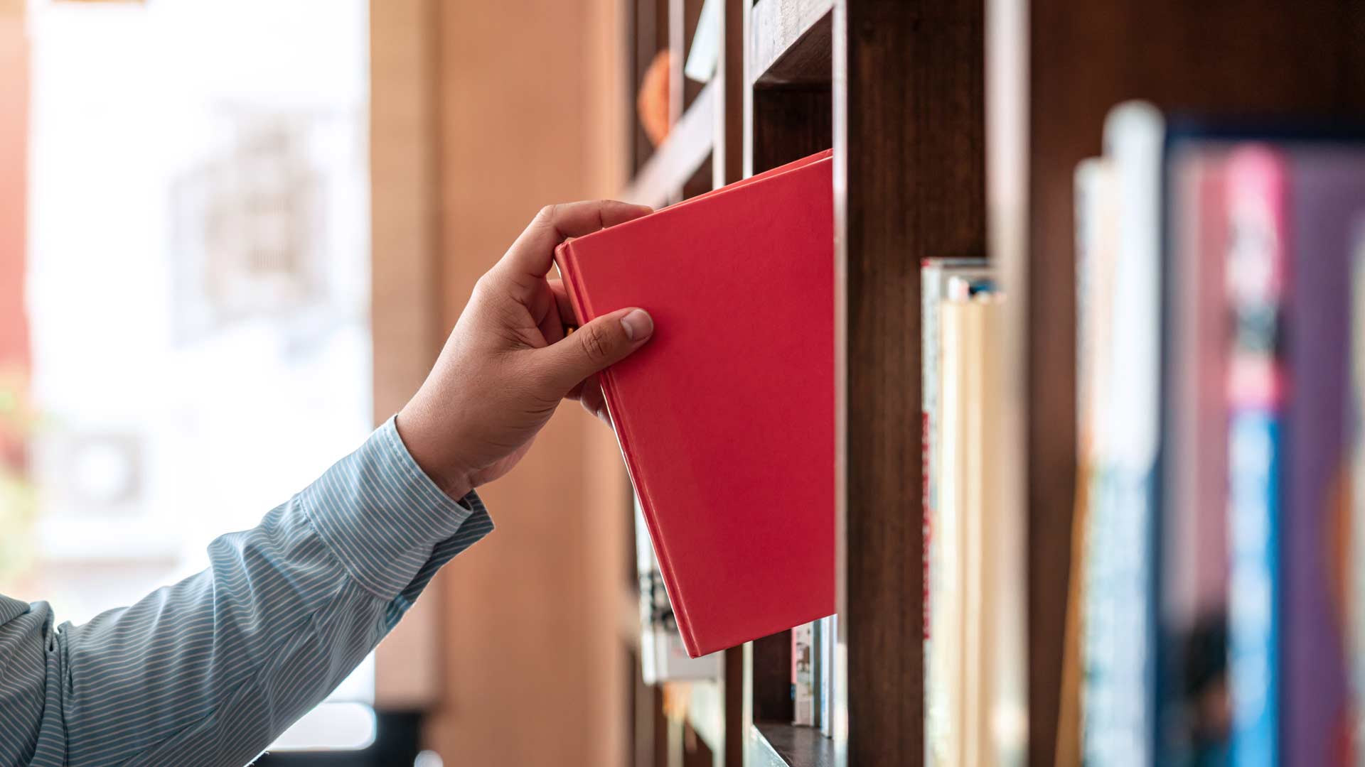 Taking book of shelf c shutterstock